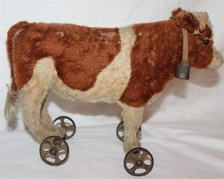 Steiff Made in Germany Antique Mohair Cow with Leather Collar and Bell Pull Toy on Wheels Circa 1590-1910. (13’W x 5”D x 10”H)