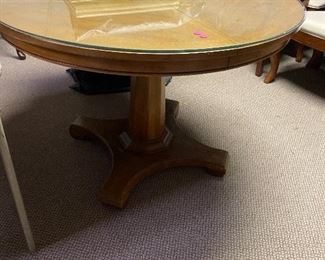 Round oak table w/2 leaves and table pads.  It has a round piece of glass to use on top