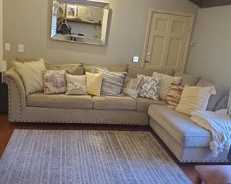 Beautiful, big traditional sectional, neutral wheat color upholstery, soft chenille upholstery, metal stud accents on this versatile sectional sofa set. Toss pillows sold separately. Mirror and large area rug sold separately.