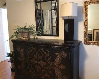 painted black sideboard, arched mirror and table lamp