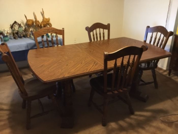 Table with leaf. It comes with five chairs and one captain chair.