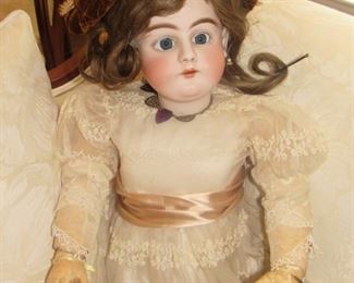 26. $200 German Doll with porcelain head, wearing jewelry and handbag, 28”