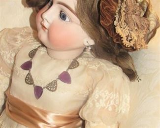 26. $ 200German Doll with porcelain head, wearing jewelry and handbag, 28”