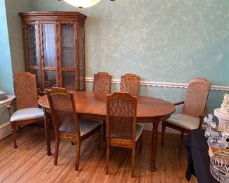 Vintage wood dining table with cane back chairs. Blue seats but super easy to change. 