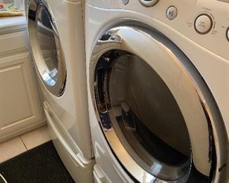 LG washer & dryer on a pedestal. 