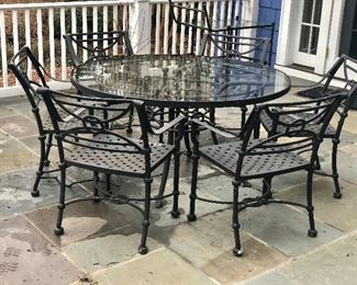 $1,600 - Brown Jordan wrought iron glass top table and six "weave" arm chairs