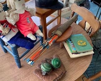 Vintage fishing reels and child baseball glove arrows 