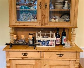 English Kitchen China Cabinet filled with Antique Salt and Pepper shakers Wall flower vases and Vintage Tableclothes