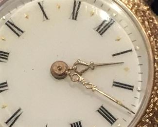 Small ornate repousse watch in 14KT gold 