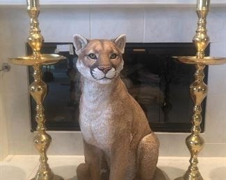 Large gold candlesticks on either side of this handsome man, he is very friendly