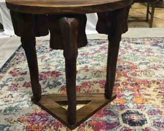 Teak wood table with elephant heads on corners