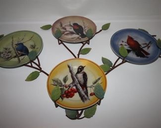 $25. Four bird plates on wall hanger