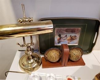 Brass desk lamp; globe bookends; duck tray