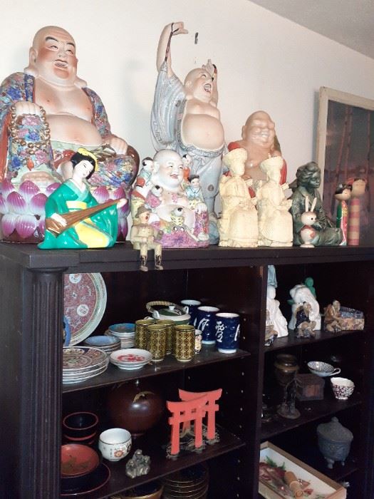 Buddhas and one of several shelves full of oriental goods