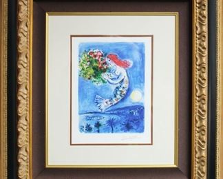 Marc Chagall La Baie des Anges (The Bay of Angels), 1962 is stunning and iconic lithograph showcasing the artist's passion for color. No place inspired Chagall more than Nice, and this fruitful partnership of love and admiration is perfectly encapsulated in the magical work before you. A stunning blue siren floats above the beautifully detailed city, wistfully reaching for an enchanting bouquet of flowers. A sense of longing and desire fill the page, as the siren refuses to make contact with the viewer and rather appears to delight in her dreamlike world. The scene is quintessentially Chagall: romantic, whimsical and surreal, like a dream; inviting you in and invoking all of your emotions and senses and memories.
SIZE: 75x83cm
