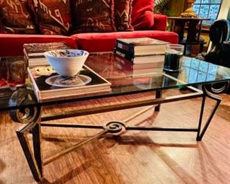 Modern coffee table with metal base and glass top. Great selection of coffee table books. 