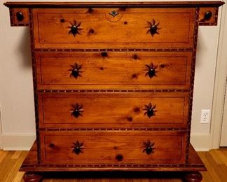 18th Century reproduction  chest from Central Luzon. Only recently have American designers rediscovered the panache of formal furniture from the Philippines. This adaptation ingeniously blends pine with walnut to achieve dimensional depth in its decorative accents. Star fruit-shaped walnut inlay anchor Barcelona brass drawer pulls. Turned feet pay homage to the Spanish craftsmen who inspired the Filipinos. Antique Brown pine finish.