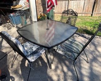 $285- Metal table with glass top and four Chairs 
