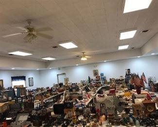 Overview of a good portion of the room with the antiques in the front row . electronics and tools on the left, THREE rows of trains on the right, housewares - kitchen and domestic etc. etc. in the middle.