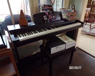 electric piano, sheet music, metranome