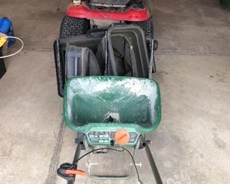 Rear bagger for a riding lawnmower and fertilizer spreader