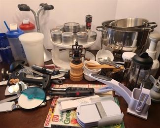 Pampered Chef chopper and small tablespoon and teaspoon measures, Plastic spice rack, metal spice holders that are magnetic, four glass wine glass holder for drying glasses and other miscellaneous items.

https://ctbids.com/#!/description/share/752991