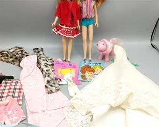 This set includes two 1963 Barbie Skipper dolls (both stamped 1963),  two Ken and Barbie books, My Little Pony (1985 Hasbro, Pat Pend, made in Hong Kong), a wedding gown, a pink formal gown, and more.

https://ctbids.com/#!/description/share/752914