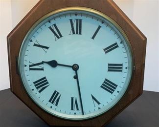 A vintage wooden wall clock with glass front hinged face. Roman numerals on the face. No name or makers mark found.

https://ctbids.com/#!/description/share/753064