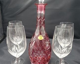 Beautiful red lead crystal decanter made in West Germany measures 13"H x 4"L and four glasses measure 7 1/2"H x 2"L.

https://ctbids.com/#!/description/share/752896