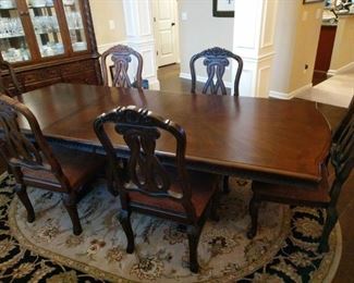 Beautiful pedestal table and 6 chairs from Ashley Furniture North Shore collection. Table has a classic trestle base and scalloped edge. Made of veneers, wood, engineered wood and cast resin. 

At it's pictured length, it has 2 leaves of 18" each. Table 9 ft x 44" and 30" high Chair height 44" at back, 20" at seat Chair seat 23"x19"  https://ctbids.com/#!/description/share/752890