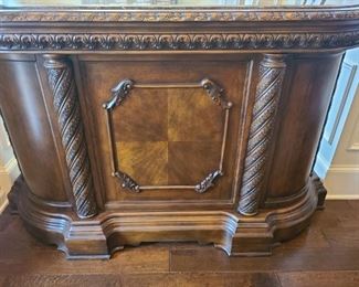 This bar from Ashley Furniture is gorgeous and matches many items in this sale. Serve drinks and appetizers to your guest tastefully. Authentic marble top and marble pull out cutting board. The wine rack can hold up to twelve bottles. Multiple drawers and storage areas hold a variety of things. Measures 66" x 21" x 43".

https://ctbids.com/#!/description/share/753009