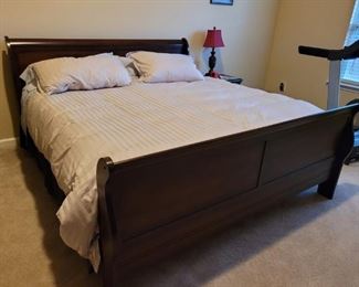 King size sleigh bed complete with mattress pad. Also includes sheets and down comforter with stripe duvet and matching pillows. The head board is 43" tall and 78" wide. The length of the bed is 91" long. The frame has an 8" clearance underneath the bed and the side board is about 13" tall. The footboard is 35" tall and 78" wide. This bed was in a spare room and barely used. Mattress and box spring are also included. They are 81" long and 76" wide.

https://ctbids.com/#!/description/share/752829