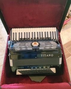 Titano Virtuoso Accordion (Four Quad/Reed) Beautiful piece in excellent condition! There is some light wear on a few buttons as pictured.