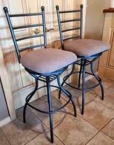 Pair of Swivel Bar Stools. Both are in excellent condition. Each chair measures 18” wide, 18” deep, 32” high to the seat and 48” high to the chair back.
