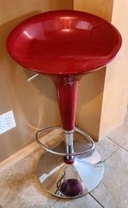 Adjustable Red Bar Stool. Nice chair with adjustable height. The seat measures 17” wide and 15.5” deep.