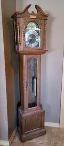 Vintage Grandfather Clock. There is some damage to the face and top of the clock as pictured. This clock was not tested and unknown if in working condition. Measures 16" wide, 10" deep and 73" high.