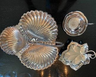 Lot 69: $60- Lot of 3 handled silver plate dishes- tea strainer with under dish, leaf dish and large 3 part shell dish with handle and shell feet-10-1/2"