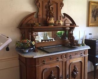 Victorian Renaissance style faded oak, white marble-top mirrored back side cabinet, last quarter 19th century.