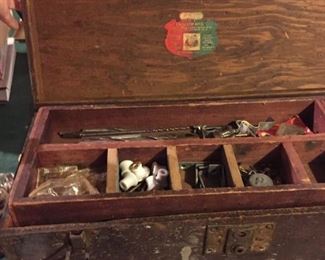 Vintage wooden tool box filled with tools.