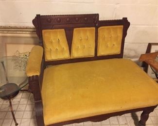 Victorian style gold plush love seat.