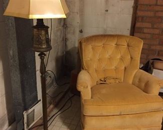 Tufted gold armchair and floor lamp.
