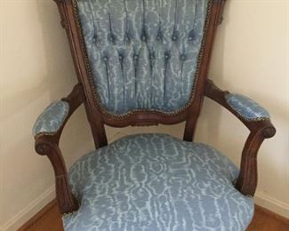Victorian style upholstered chair with wood frame.