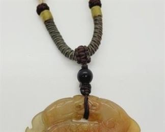 2149 - Carved Jade Pendant on woven necklace 32" 