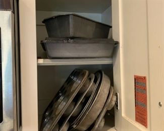 Everybody has that one cabinet like this, full of random baking pans, in their kitchen - even people who don't cook.  It's like mandatory.  I think it just comes with the house.  