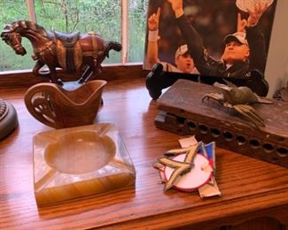 Wow, super bad lighting but there are a couple of cool pieces in this picture.  There's an old cigar press, an old hand carved Yugoslavian  cup, an old horse, and an old coach!