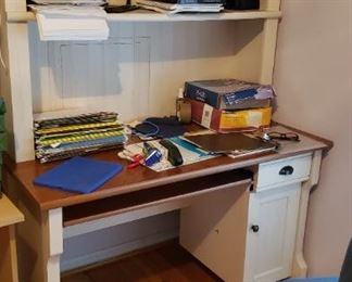 Desk with book shelves above; office chair