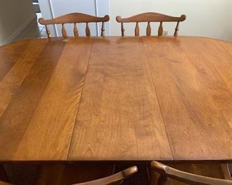 Beautiful solid wood table with 6 chairs and leaf.