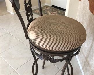 Front of elegant wrought iron and wood bar stool