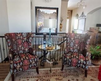 Brown with red and blue bold print wingback chairs. 