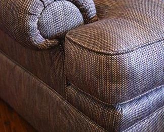 large chair with decorative pillows and ottoman